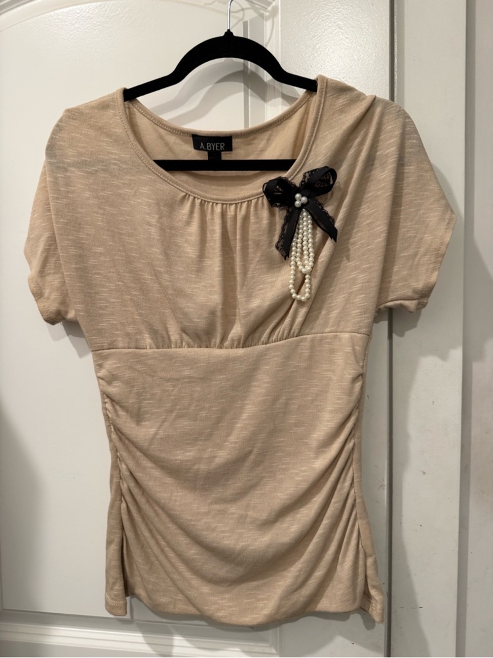 A. Byer Beige Short Sleeve Tunic with Black Bow & Pearl Accent